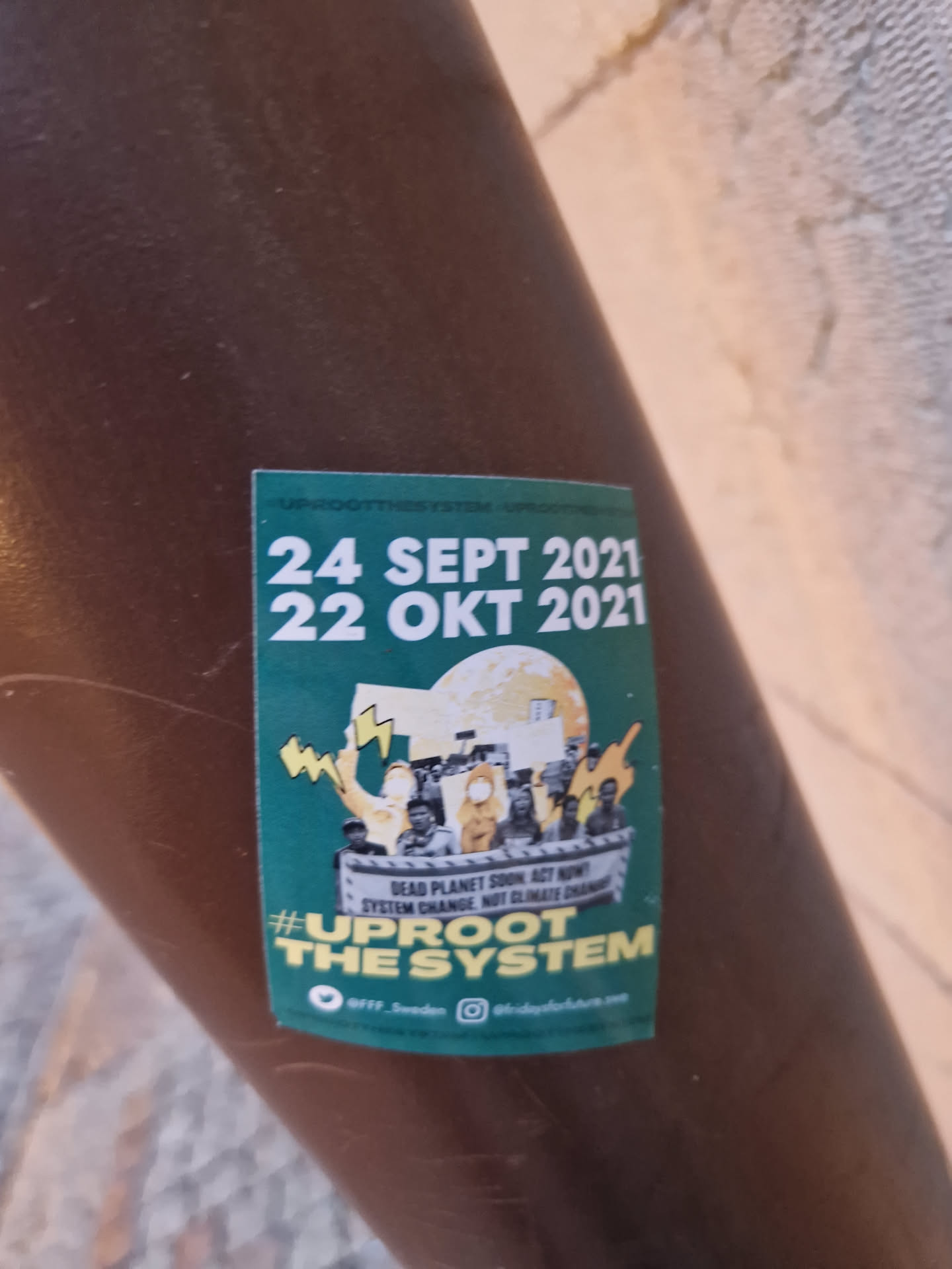 Sticker promoting climate action with the dates of a potential event or protest.  It shows an illustration of people protesting. The text on the sticker says:
Dead Planet Soon, Act Now
System Change Not Climate Change