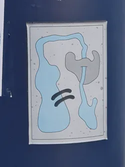 A sticker with an abstract design featuring blue and grey shapes on a light grey background. The shapes appear organic and fluid, resembling a minimalist landscape or map.  The sticker has a slightly worn or speckled appearance.