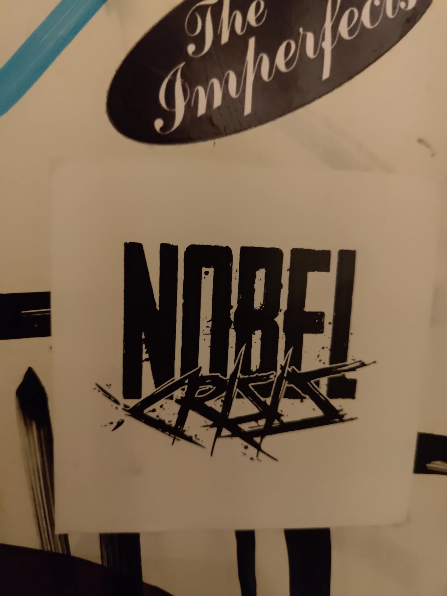 A black and white sticker with the text NOBF! and Crisis written in a stylized font. The text is bold and edgy.