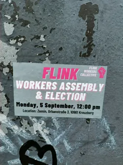 A sticker announcing a Workers Assembly and Election for the FLINK Workers Collective, taking place on Monday, September 5th at 12:00 pm in Zemin, Urbanstraße 3, 10961 Kreuzberg.
