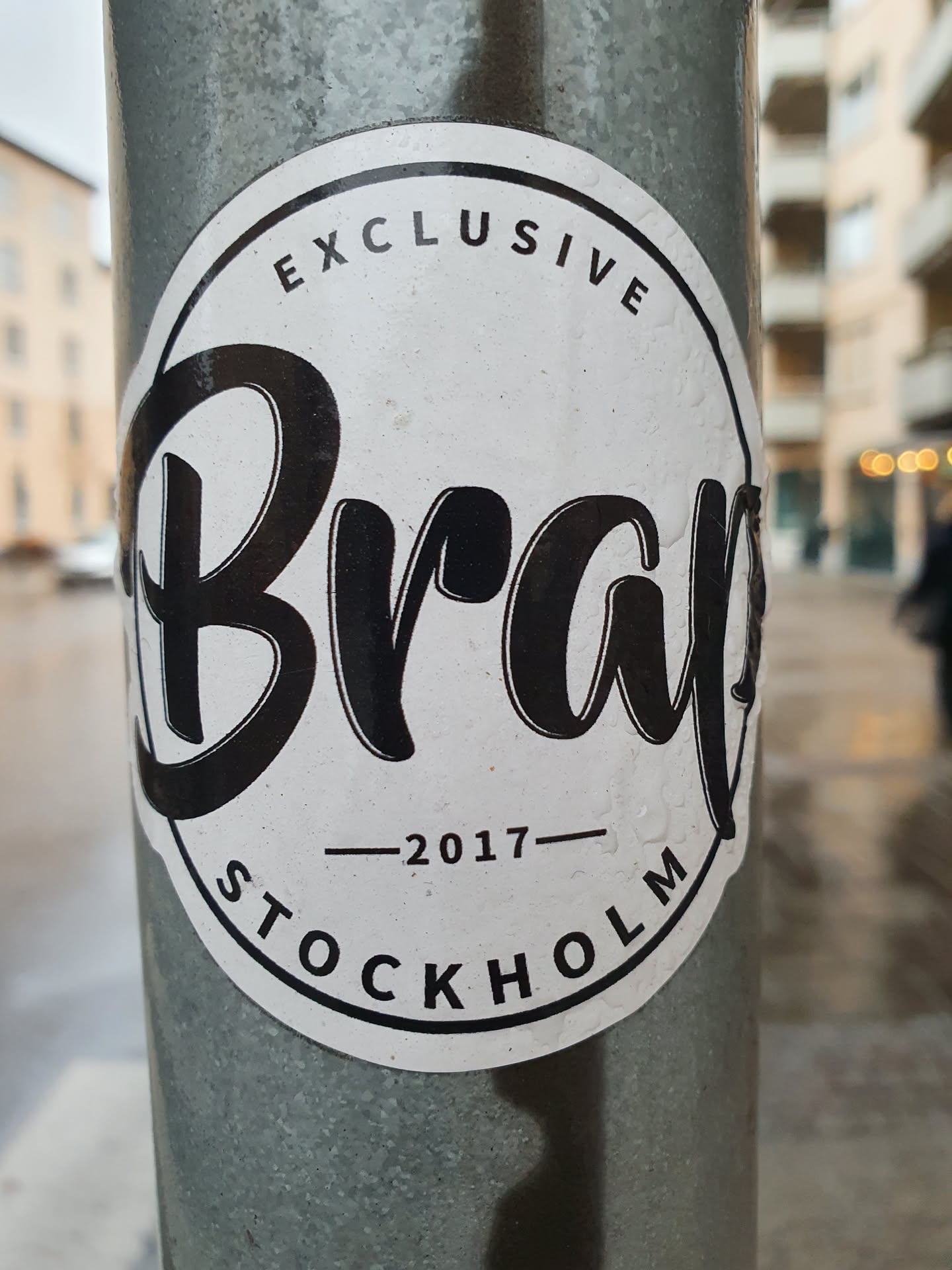 A round white sticker with black text.  The word 'Brap' is prominently displayed in a stylized script font.  Above 'Brap', it says 'EXCLUSIVE' in a smaller font and below it says '-2017- STOCKHOLM'.