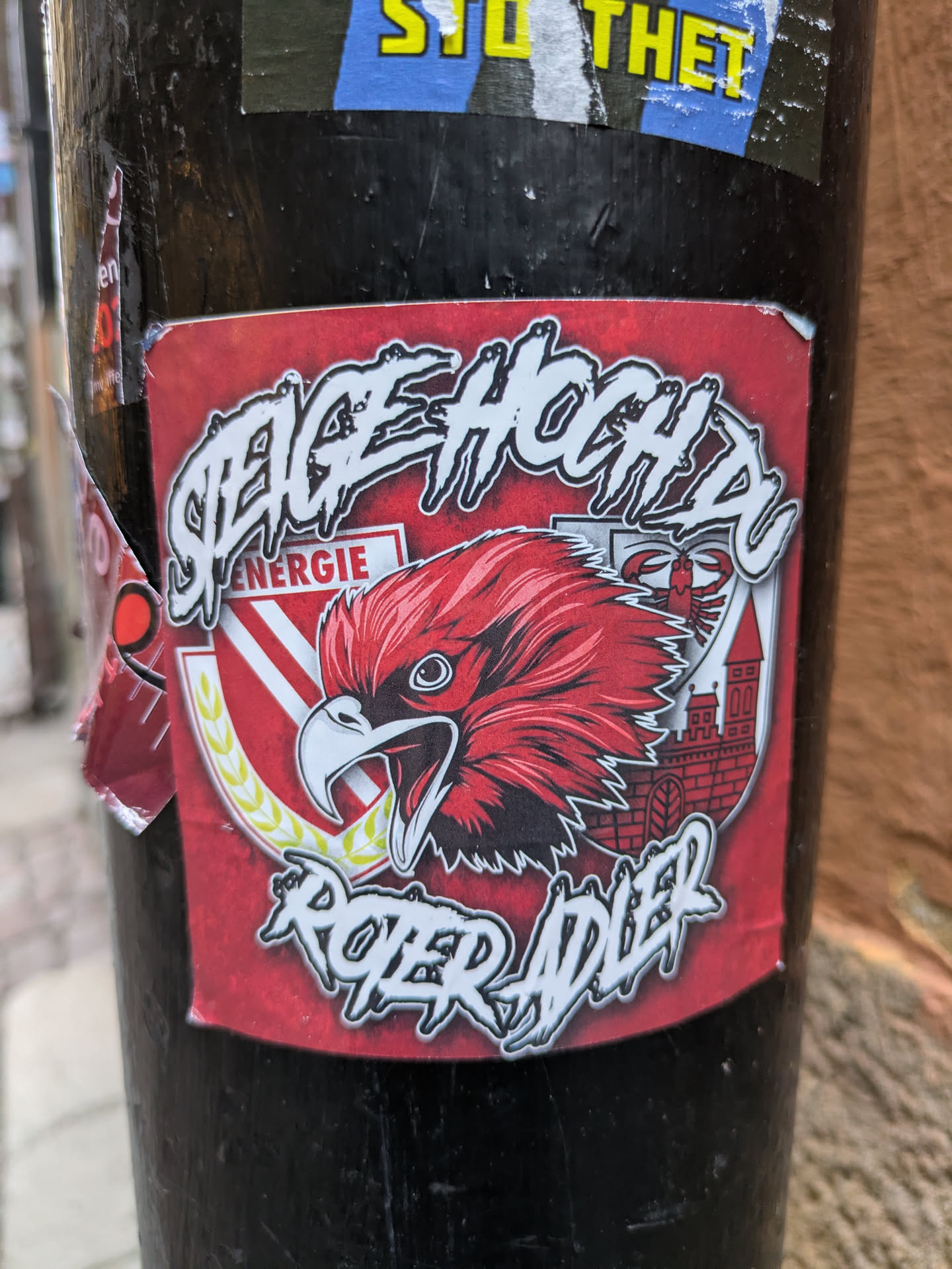 A red sticker with a illustration of an eagle and text that says "Steige hoch du roter adler".