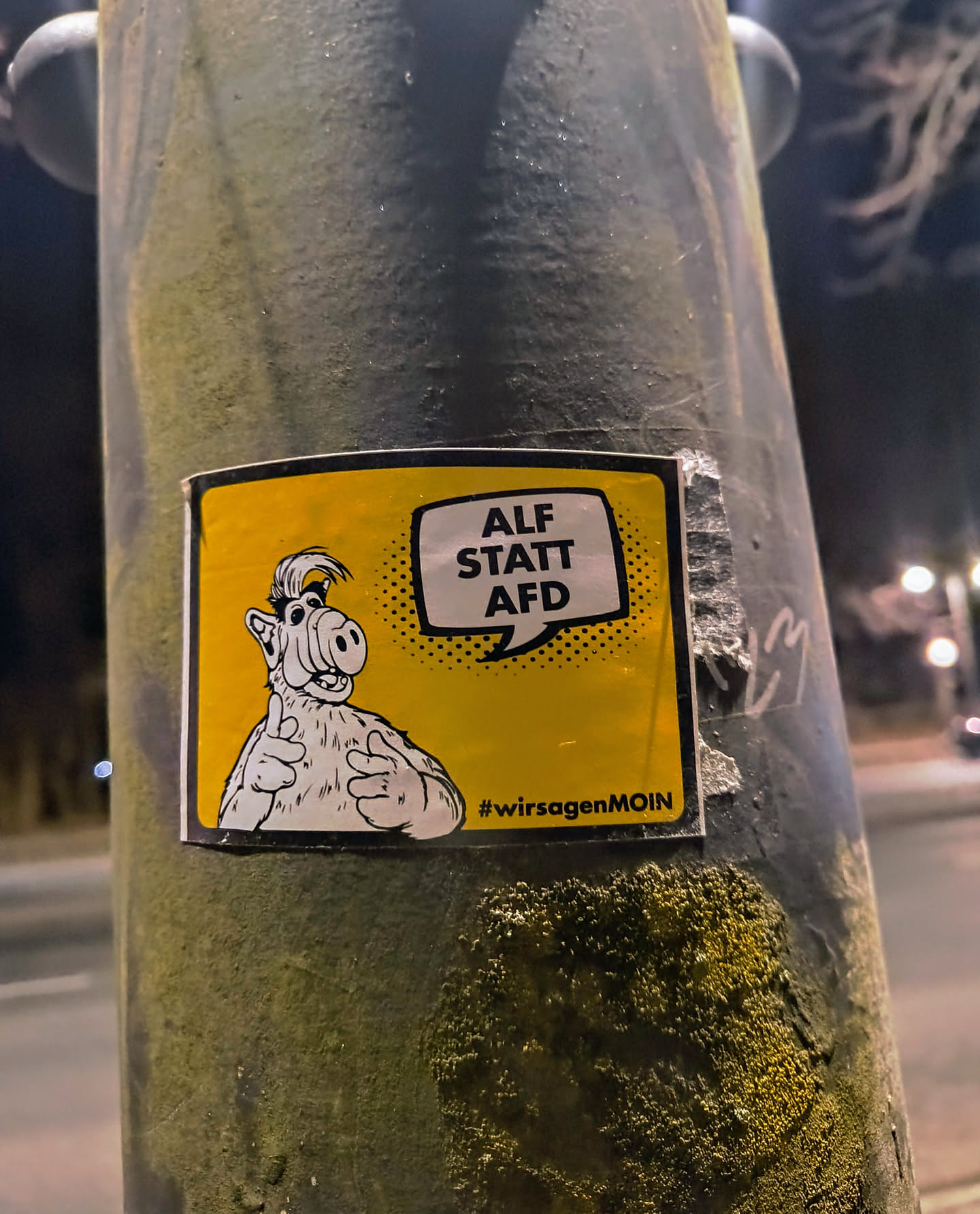 A sticker featuring Alf from the TV show Alf, with a speech bubble saying "ALF STATT AFD".  The hashtag #wir sagenMOIN is also included.  The sticker is yellow with black text and image.