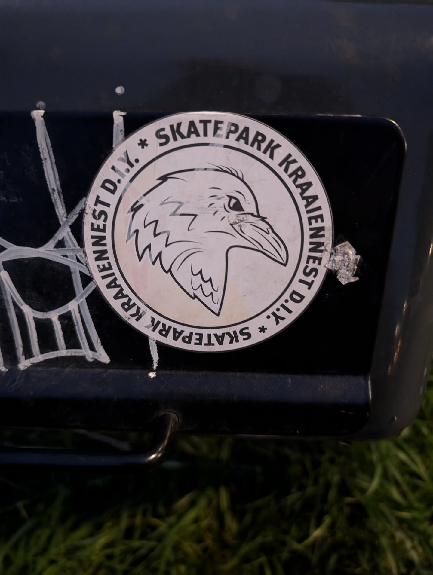 Round sticker featuring a crow head graphic and text. The text on the sticker says "KRAAINEST D.I.Y. * SKATEPARK KRAAINEST D.I.Y." arranged in a circular pattern.