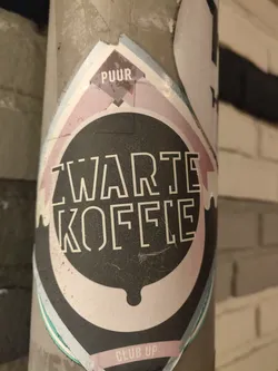A black and white sticker with the text 'Zwarte Koffie' (Dutch for Black Coffee) in a stylized font. The sticker also features the words 'PUUR' and 'CLUB UP'.