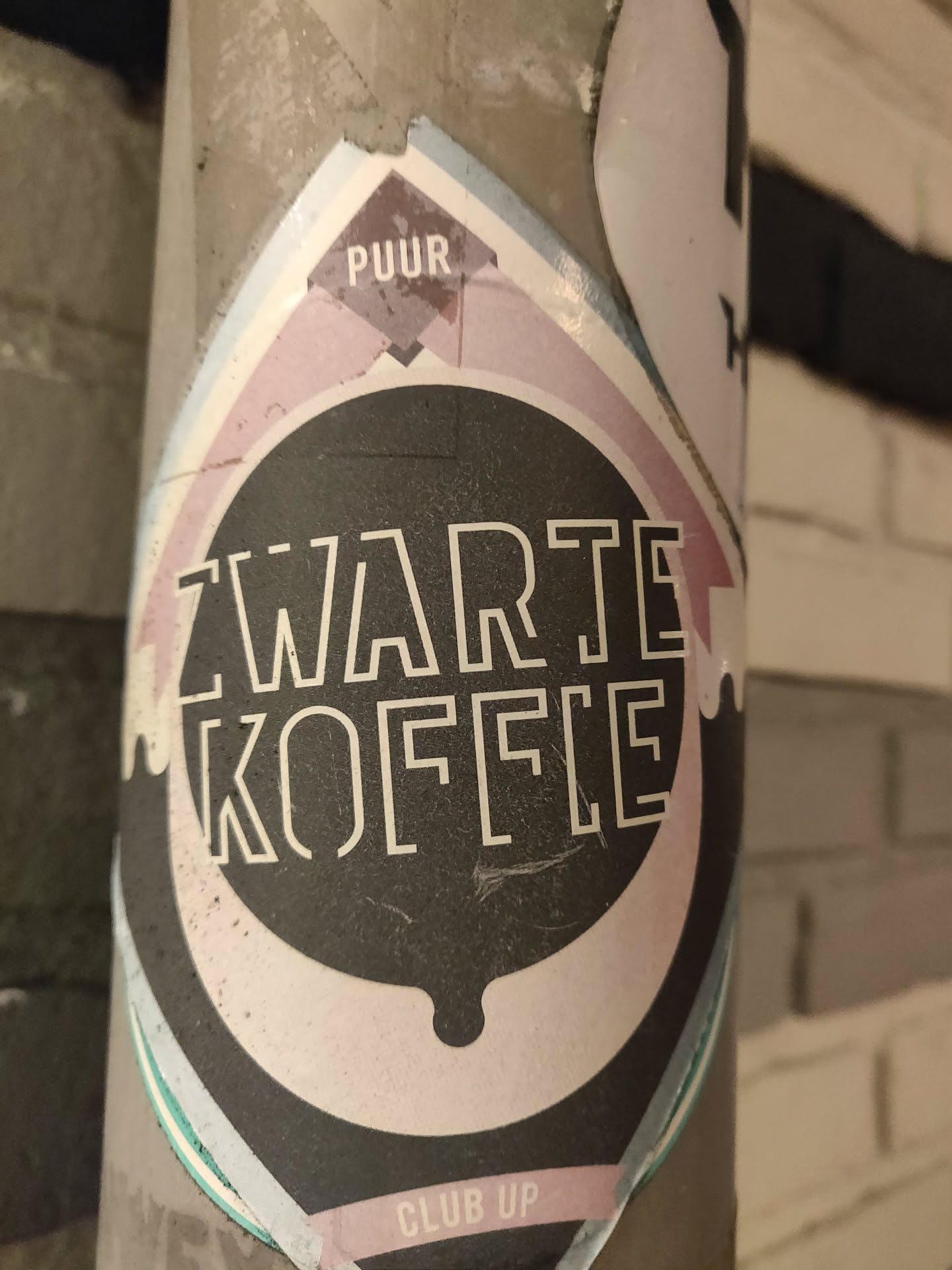 A black and white sticker with the text 'Zwarte Koffie' (Dutch for Black Coffee) in a stylized font. The sticker also features the words 'PUUR' and 'CLUB UP'.