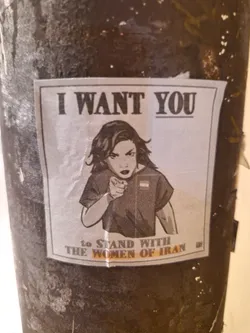 A sticker featuring a woman pointing at the viewer with the text: I WANT YOU to stand with the women of Iran.