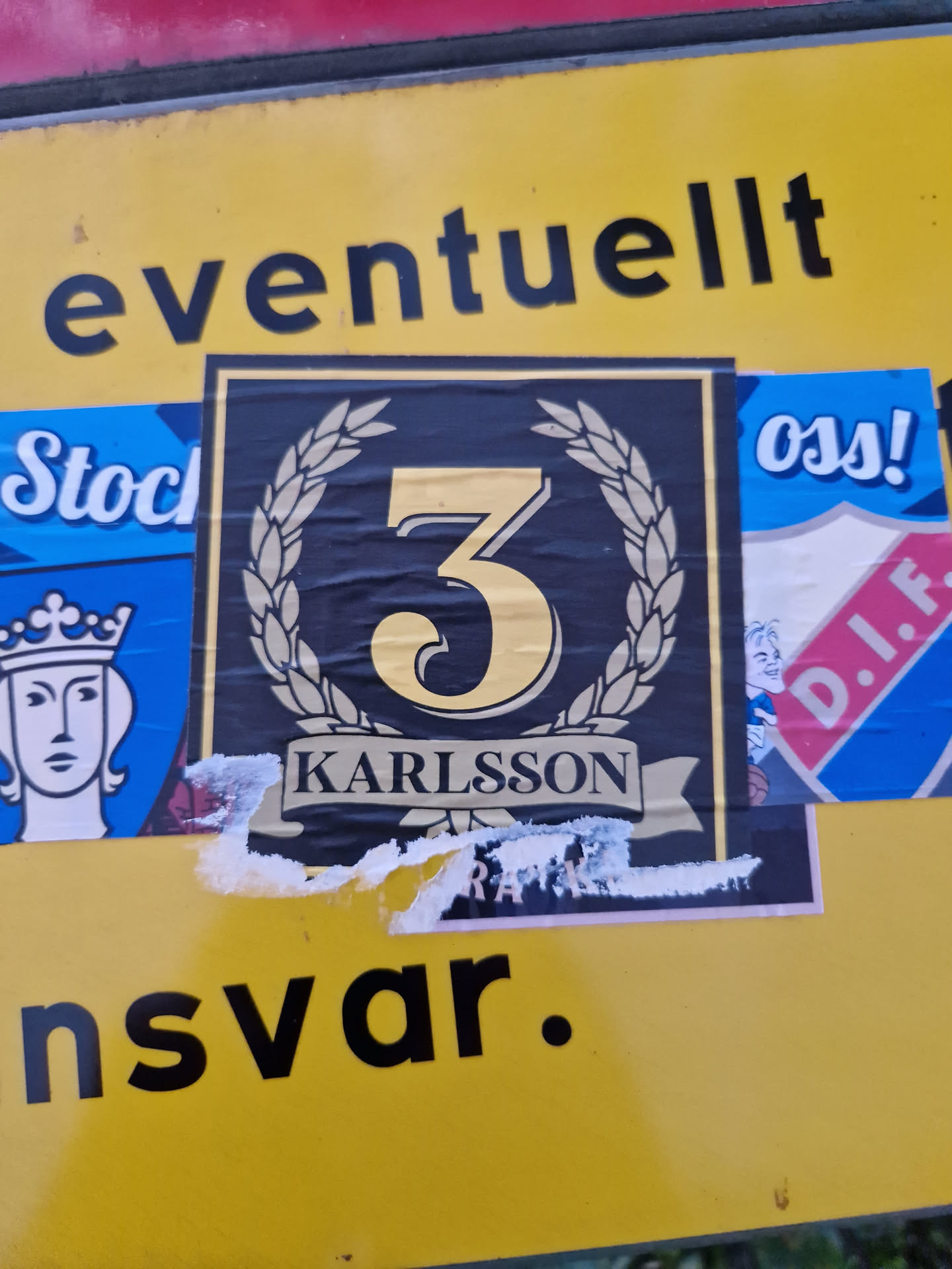 A black and gold sticker with the number 3 in the center, surrounded by a laurel wreath.  The text 'KARLSSON' is visible at the bottom. The sticker shows some signs of wear.