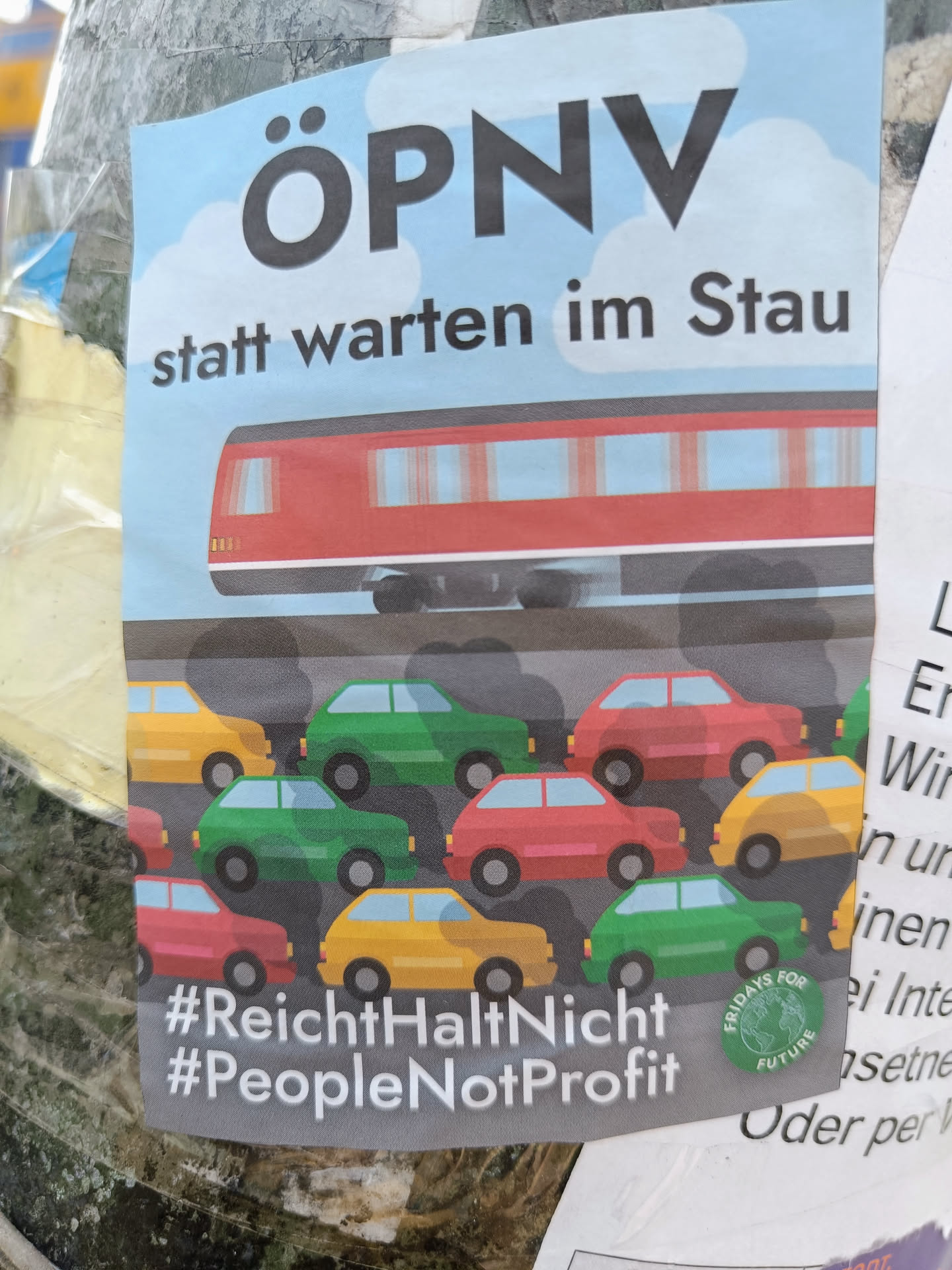 A sticker advocating for public transportation. It depicts a train contrasted with cars stuck in traffic. Hashtags promote social movements.