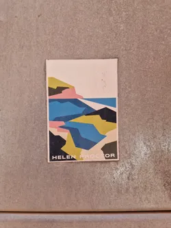 A minimalist sticker featuring an abstract geometric interpretation of a coastal scene. The design is primarily composed of blocks of blue, yellow, pink, and black, suggesting water, land, and sky.  The artist's name, "Helen Proctor," is printed at the bottom.