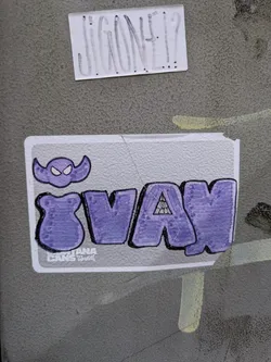 Purple and white sticker with the word Svax in bubble letters. There is a small illustration of a ghost-like creature above the word. The sticker also has a small logo that reads 'Louisiana Cans'.