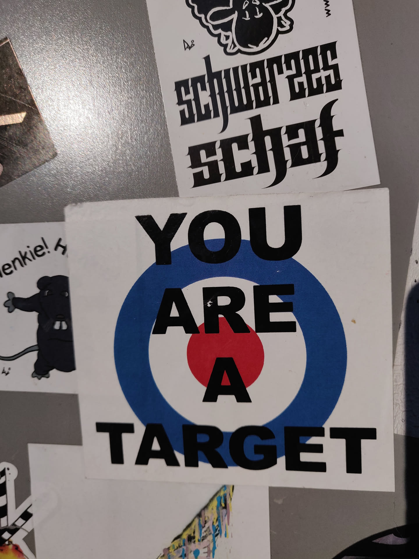 A sticker with a target graphic and the text "YOU ARE A TARGET" printed on it. The target is blue, white and red.