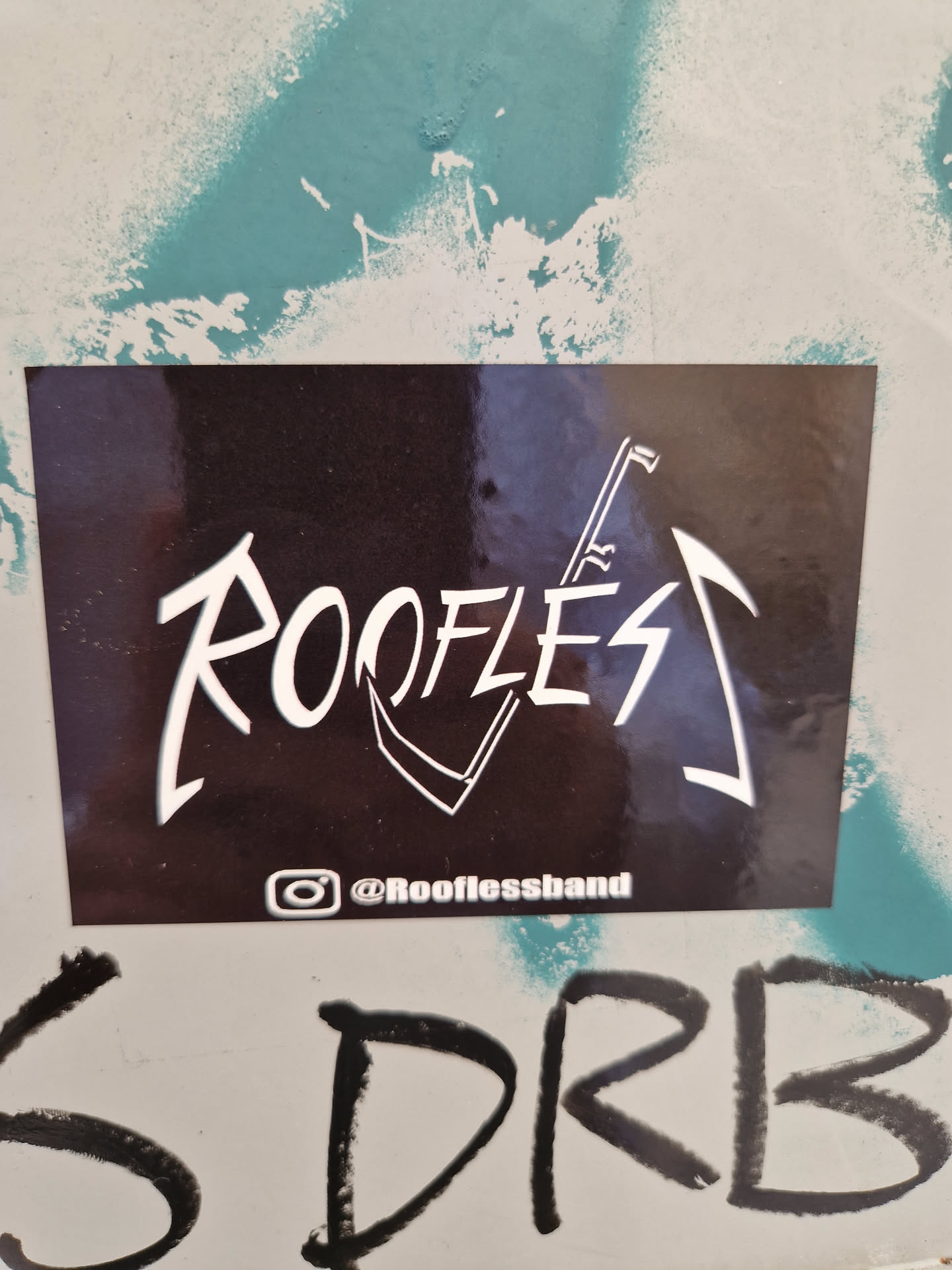 Black and white sticker with the band's logo and Instagram handle.
