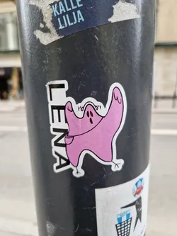 A pink ghost-like creature with a small pocket is featured in this sticker. The name "Lenya" is written vertically alongside the illustration. 