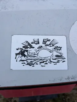 Street sticker A rectangular white sticker printed with a high-contrast black ink drawing. In the foreground, an exhausted or run-over cartoon frog lies flattened on the ground among dark ink puddles. Arcing over the frog's back is the handwritten phrase 'Fuck Hela Samhället!'. Above the scene, stylized, cross-hatched sun rays burst upwards surrounded by ink splatters.