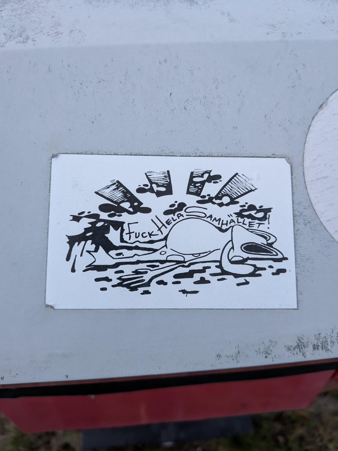 A rectangular white sticker printed with a high-contrast black ink drawing. In the foreground, an exhausted or run-over cartoon frog lies flattened on the ground among dark ink puddles. Arcing over the frog's back is the handwritten phrase 'Fuck Hela Samhället!'. Above the scene, stylized, cross-hatched sun rays burst upwards surrounded by ink splatters.