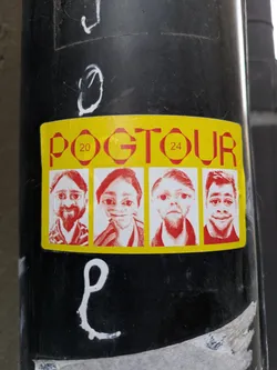 Yellow sticker with red text and four portraits. The text says POGTOUR with the numbers 20 and 24 on each side. The portraits appear to be stylized or caricatured faces.