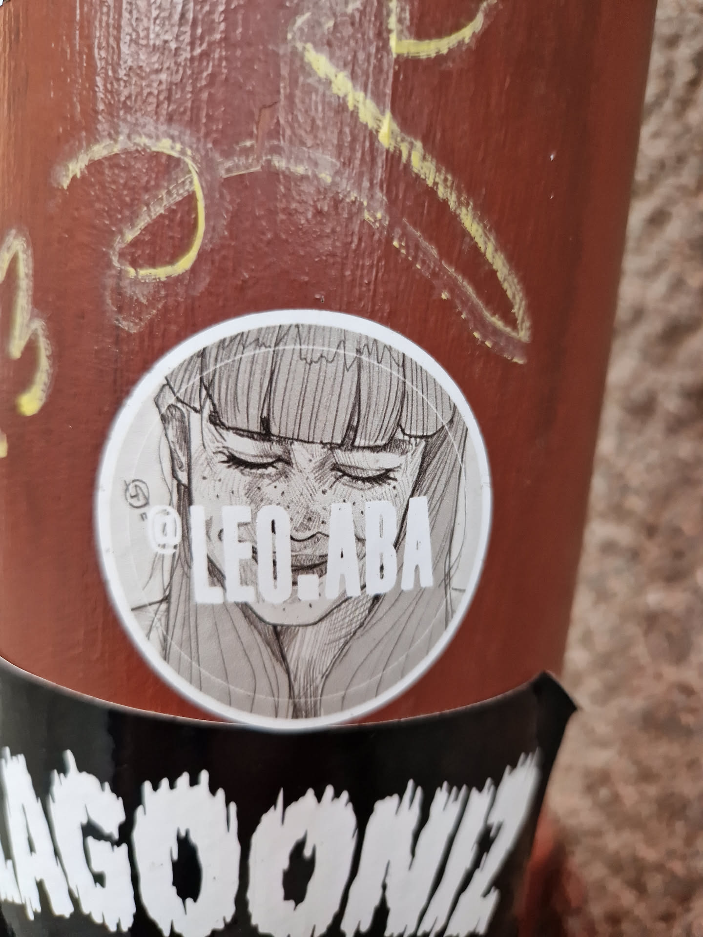 Round sticker featuring a grayscale sketch of a woman's face. The artist's Instagram handle is printed at the bottom of the sticker.