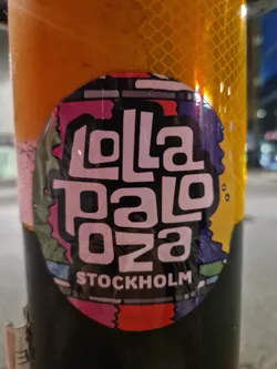 Round sticker with the text "Lollapalooza 023" in a stylized font and the word "Stockholm" below it. The background is colorful and abstract.