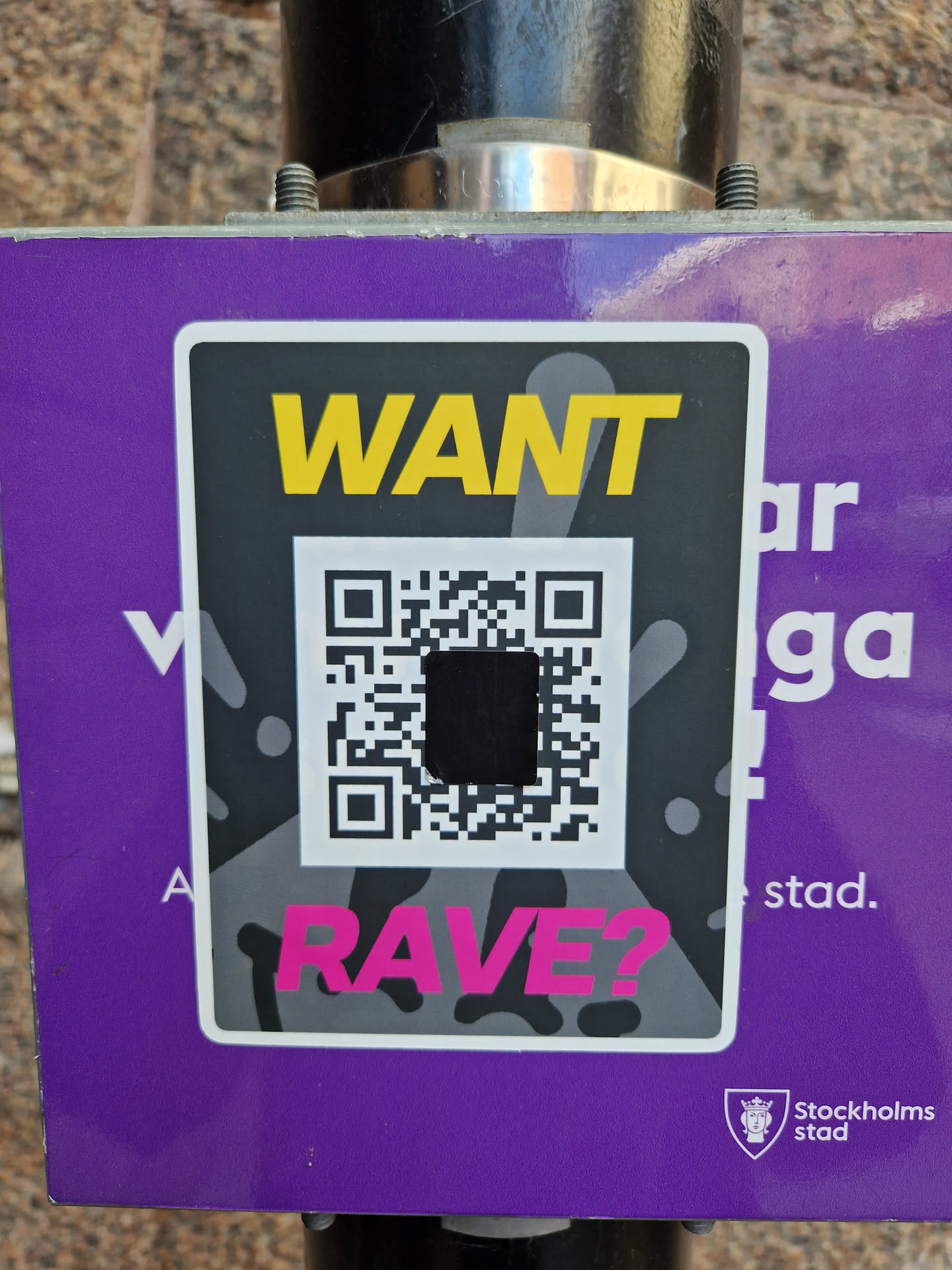 A purple sticker with a QR code in the center. The text 'WANT RAVE?' is written on it, with 'WANT' in yellow and 'RAVE?' in pink. The Stockholm City logo is visible at the bottom right corner.