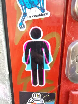 A sticker depicting a person with both male and female symbols superimposed. The design is minimalist and uses a bold color scheme.
