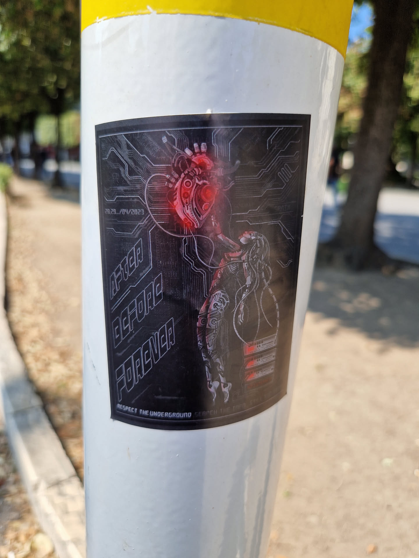 A sticker featuring a dark, cyberpunk-esque design with a central image of a mechanical heart connected to circuitry.  The text 'Never Before Forever' is prominently displayed, along with the smaller phrase 'Respect the Underground'. The artwork suggests a blend of organic and technological elements.