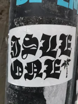 Black and white sticker with a palm tree and the text "Dope style" written in a gothic style font. 