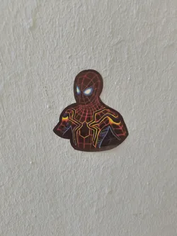 A vinyl sticker featuring the Iron Spider-Man suit from Marvel Comics and the Marvel Cinematic Universe. The sticker is predominantly red and gold with black accents, and depicts Spider-Man's face and upper body.
