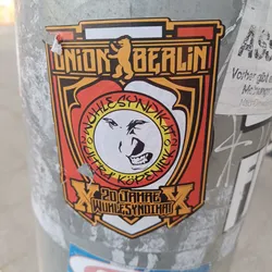 A sticker commemorating 20 years of Wuhlesyndikat, a Union Berlin fan club. The design features the Union Berlin logo and a stylized bear face.