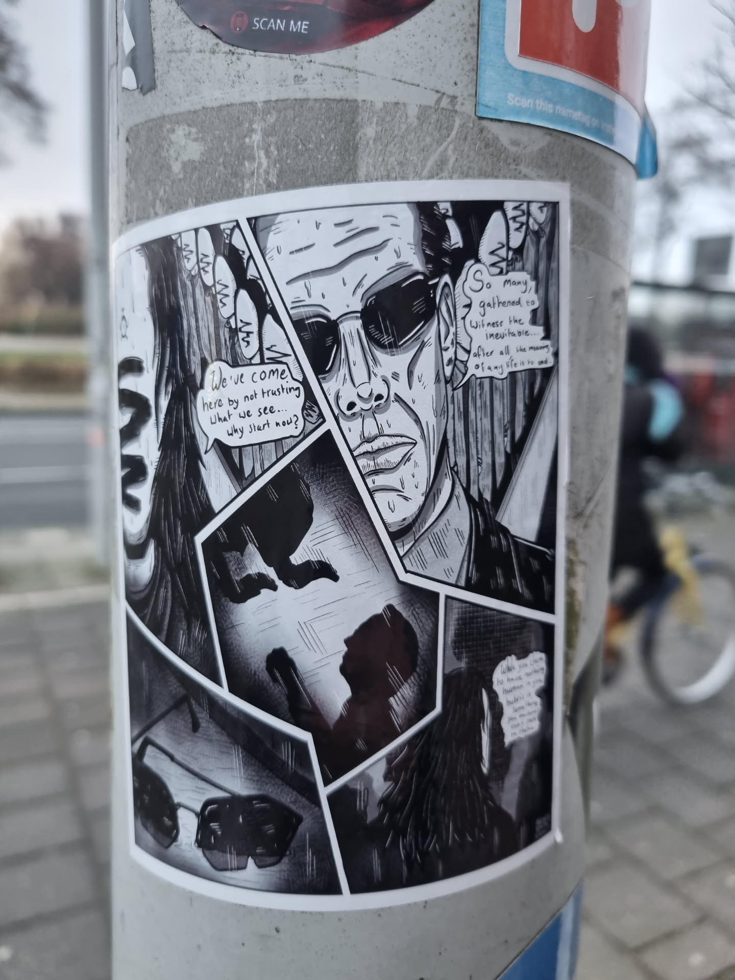 This sticker shows a comic-style illustration in black and white. A man with sunglasses is the main focus, and there are several smaller panels that seem to tell a story. The text in the speech bubbles is mostly illegible, but some words are visible.  The style is reminiscent of graphic novels or manga.