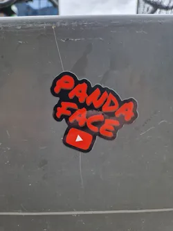 Red and black sticker with the text "Panda Face" in graffiti style and a YouTube play button. 