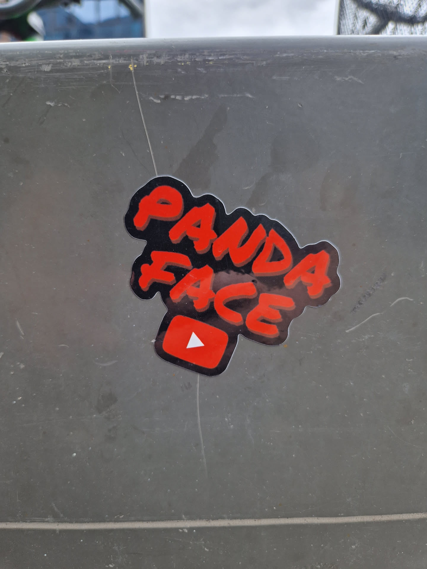 Red and black sticker with the text "Panda Face" in graffiti style and a YouTube play button. 