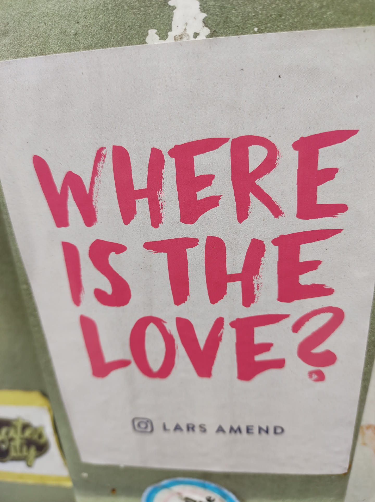 A sticker with the text 'Where is the love?' written in a pink brush script.  The Instagram handle @larsamend is visible at the bottom.