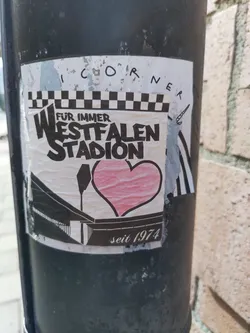 A sticker expressing love for the Westfalenstadion, a football stadium in Dortmund, Germany, that opened in 1974. The design features a heart and the stadium's name in a stylized font.
