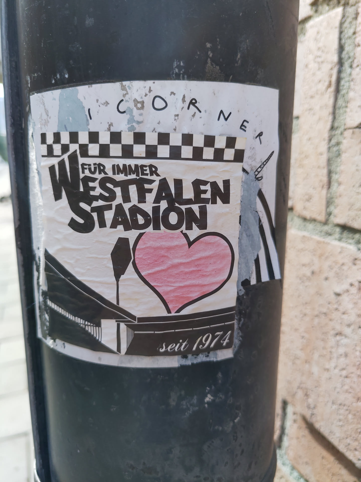 A sticker expressing love for the Westfalenstadion, a football stadium in Dortmund, Germany, that opened in 1974. The design features a heart and the stadium's name in a stylized font.