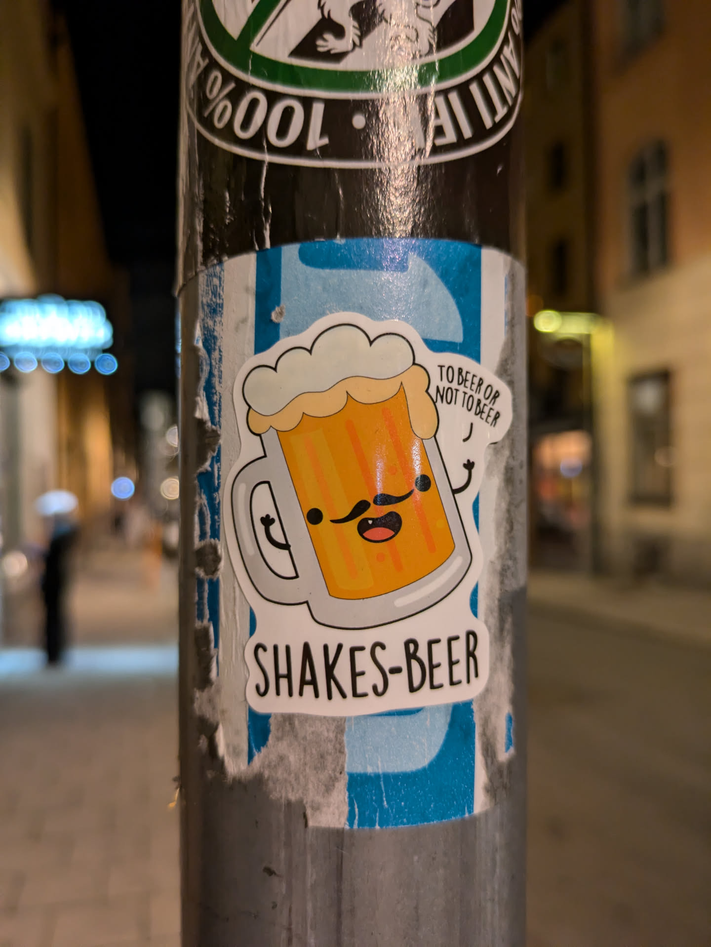 A cute cartoon beer mug sticker with a mustache.  The text on the sticker says "Shakes-Beer" and a smaller text says "To beer or not to beer".