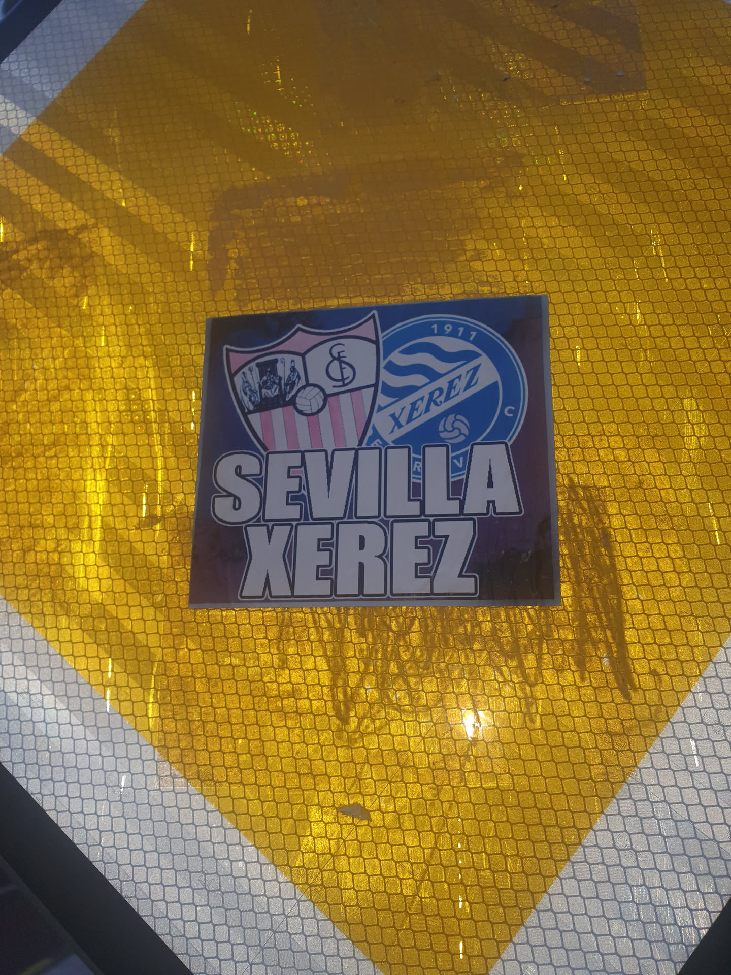 A sticker featuring the logos of Sevilla FC and Jerez Industrial CF, with the text "SEVILLA JEREZ" underneath.