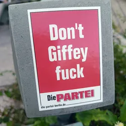 A red sticker with white text that says "Don't Giffey fuck" and the logo of the German political party "Die PARTEI".  The sticker is affixed to a gray surface. The text "die-partei-berlin.de" is at the bottom.