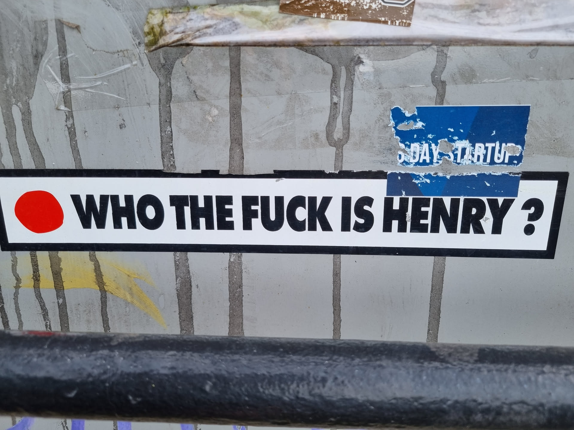 A sticker with a bold, provocative question. The sticker features a red circle on the left and black text on a white background.  A partially visible sticker above it says "5Day Startup."