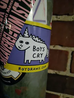A purple sticker featuring a cartoon unicorn with the text 'Boys Cry' and a website address at the bottom. 