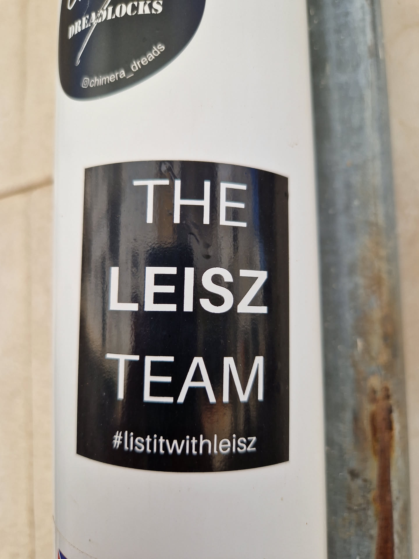 Black and white sticker with the text "THE LEISZ TEAM" and the hashtag #listitwithleisz.