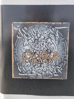 A square sticker featuring intricate black and white graffiti art on a gray background with a circular maze pattern.  Some elements of the art are highlighted in a muted gold color. The style is reminiscent of calligraphy or abstract lettering.