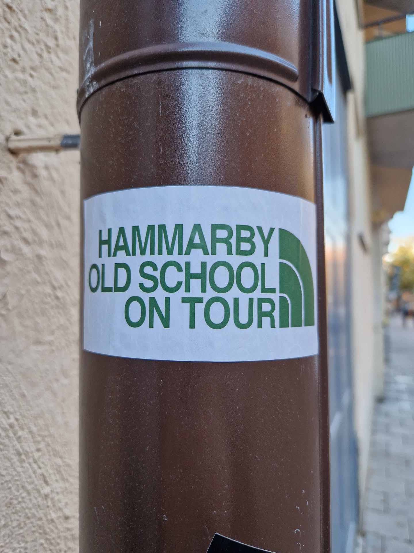 A sticker featuring the text "HAMMARBY OLD SCHOOL ON TOUR" in green lettering on a white background.  The design is reminiscent of outdoor apparel branding.
