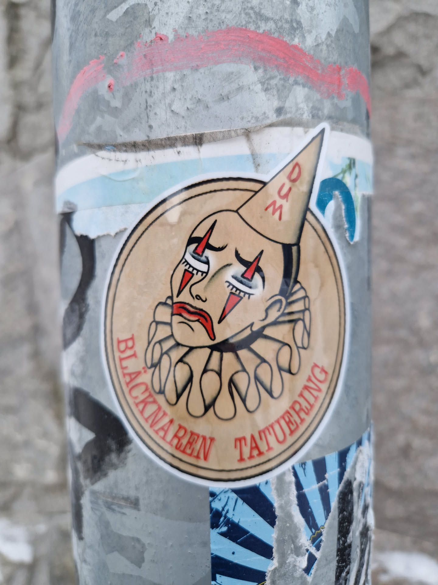 Round sticker featuring a vintage-style illustration of a sad clown wearing a dunce cap. The text around the illustration says "Blacknaren Tatuering." 
