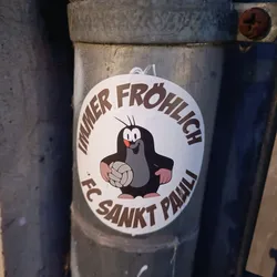 A round sticker featuring Krtek (the Little Mole), a popular Czech cartoon character, holding a volleyball. The text around Krtek says "Immer fröhlich FC Sankt Pauli", which translates to "Always cheerful FC St. Pauli".
