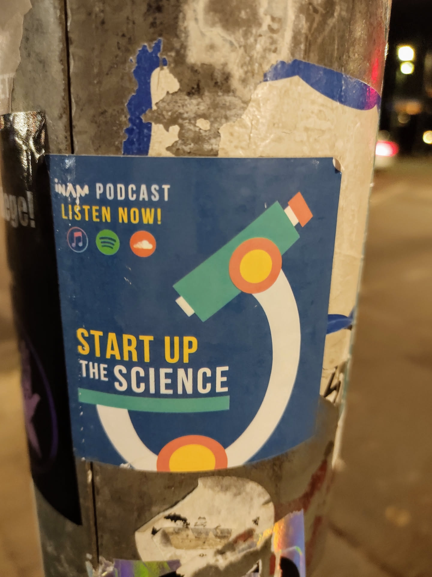 A blue sticker with a stylized microscope graphic.  It promotes the InAM Podcast and includes links to various podcast platforms.