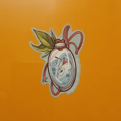 This delightful sticker showcases a unique illustration of a creature sealed within a glass bottle, adorned with leaves and a red string.  The style is whimsical and charming, with soft pastel colors and delicate linework. The artist's name and social media handle are subtly integrated into the design.