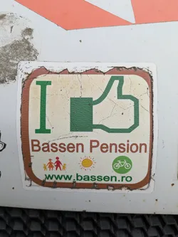An "I Like"-themed sticker promotes Bassen Pension, featuring a green thumbs-up graphic, colorful illustrations of a family and the sun, and a bicycle icon. The website address is included at the bottom.