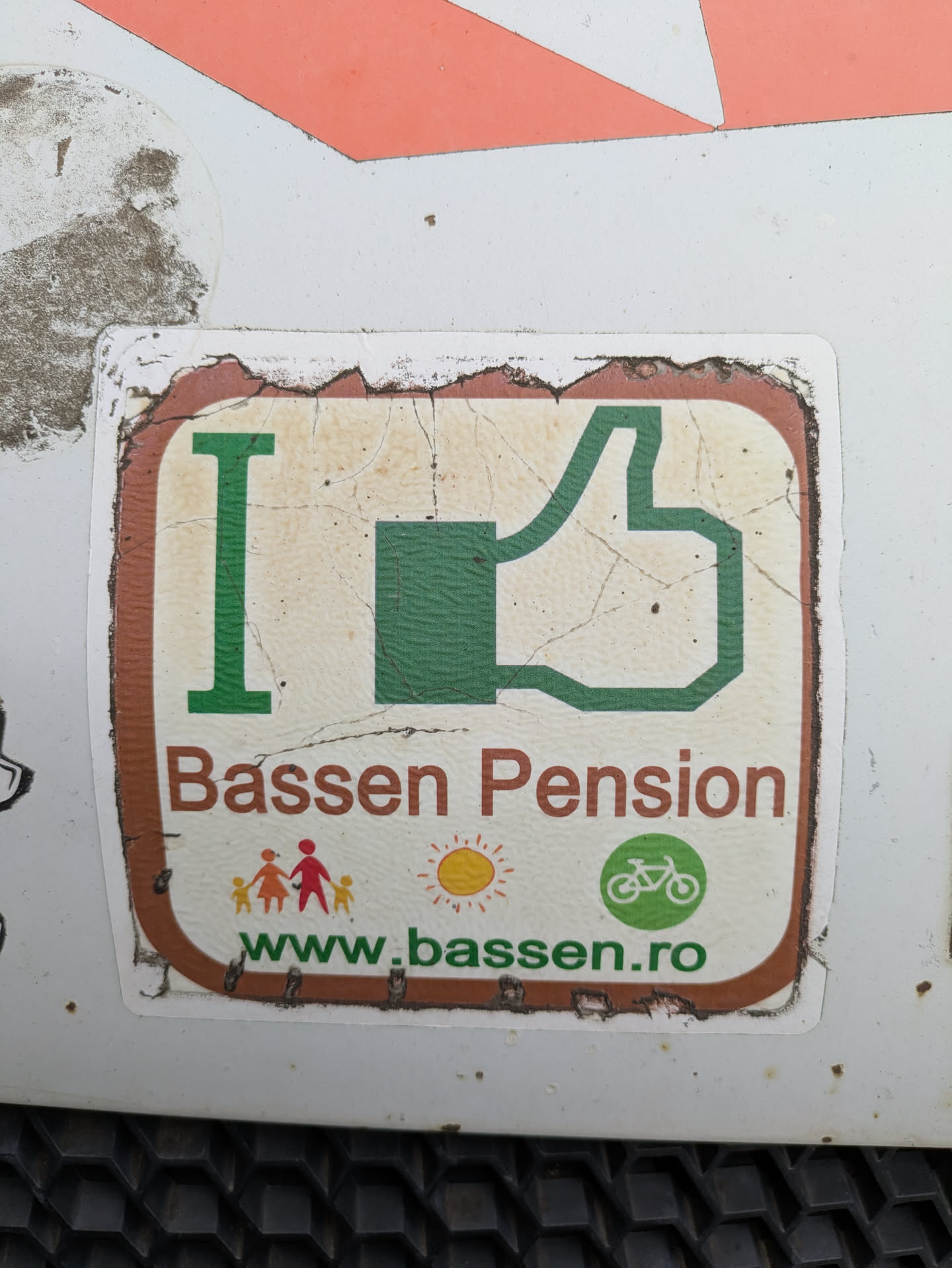 An "I Like"-themed sticker promotes Bassen Pension, featuring a green thumbs-up graphic, colorful illustrations of a family and the sun, and a bicycle icon. The website address is included at the bottom.