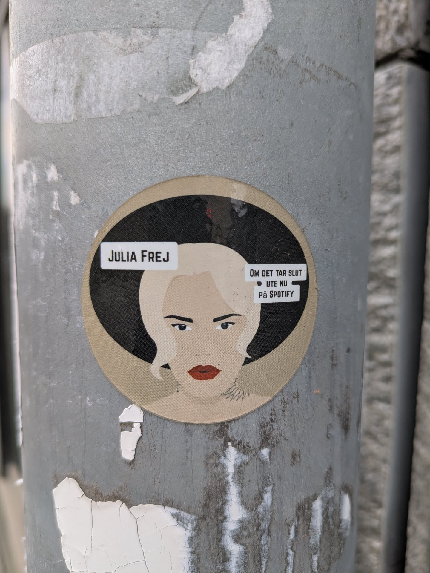 Round sticker featuring an illustration of Julia Frej.  The sticker has text indicating the song "Om det tar slutt" is available on Spotify.
